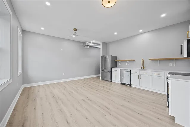 a view of a kitchen with electric appliances