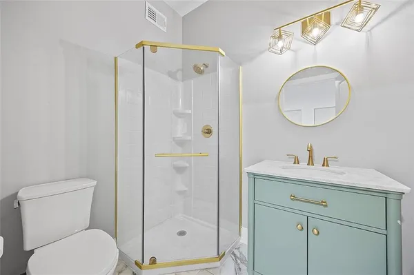 a bathroom with a toilet sink vanity and mirror