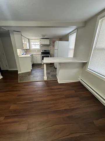 a view of kitchen and wooden floor