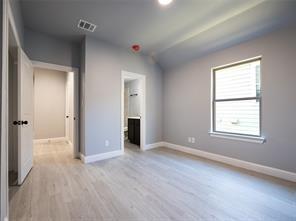 419 West Elm Street Denison, TX 75020 - Photo 5 of 9 an empty room with windows and closet