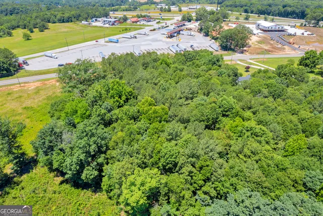 an aerial view of a houses with a yard and lake view