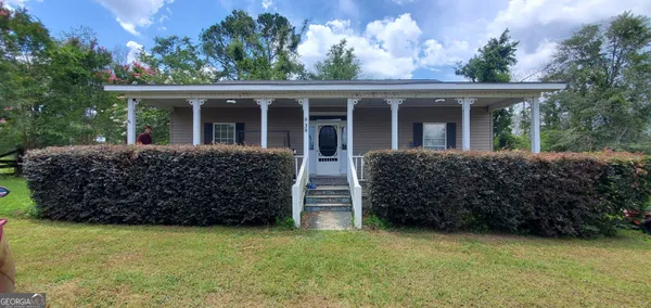 front view of a house with a yard