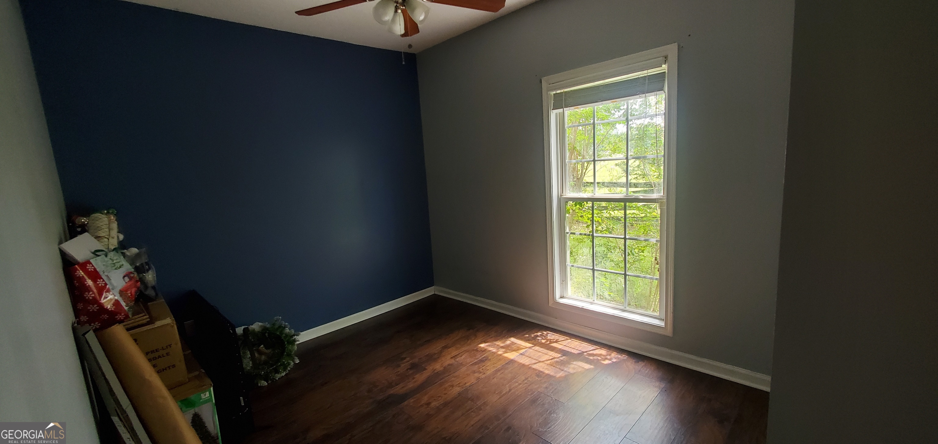38 Highway 46 Lyons, GA 30436 - Photo 11 of 44 a view of an empty room with wooden floor and a window
