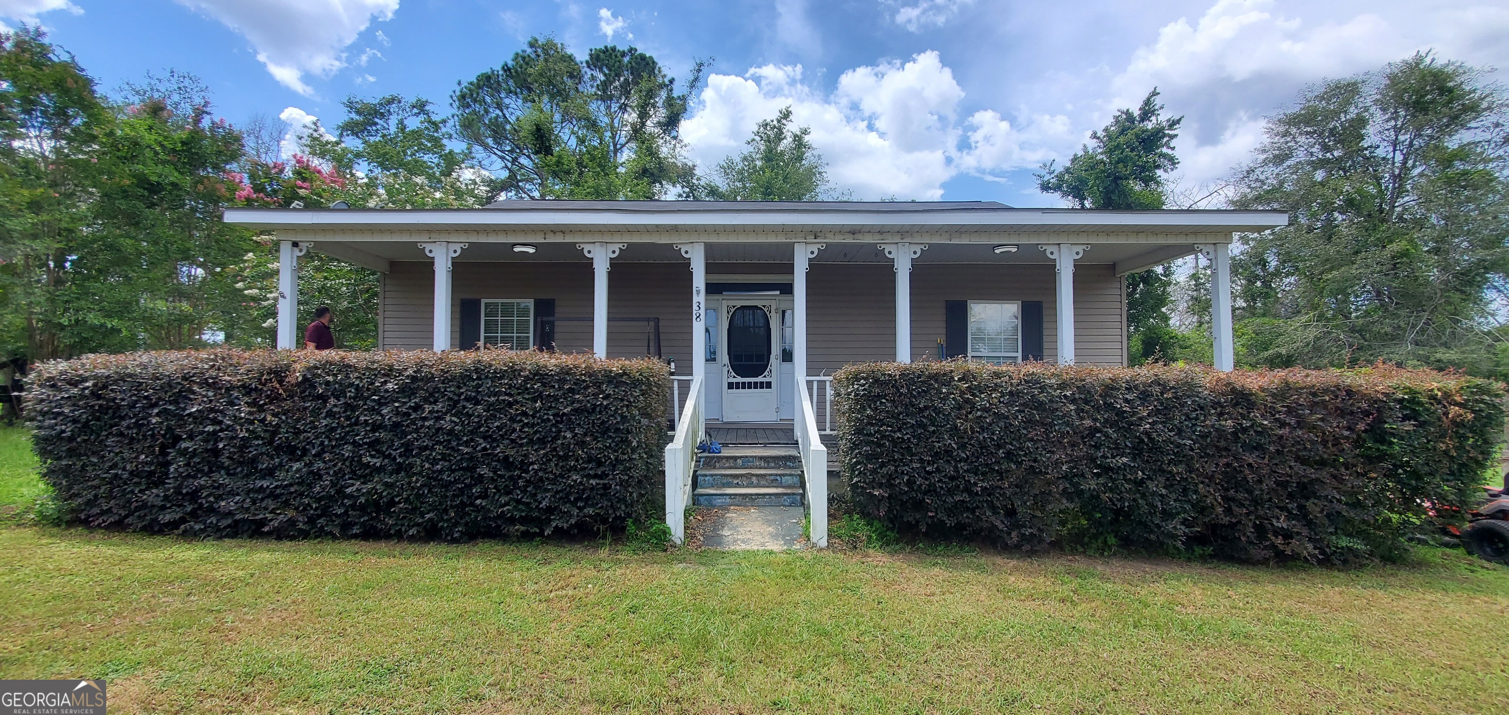 38 Highway 46 Lyons, GA 30436 - Photo 2 of 44 front view of a house with a garden