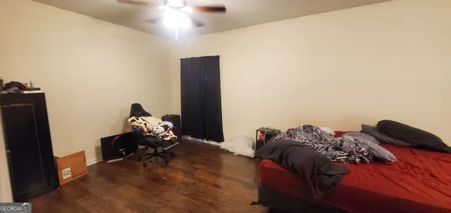 a bedroom with a bed and a flat tv screen on a dresser