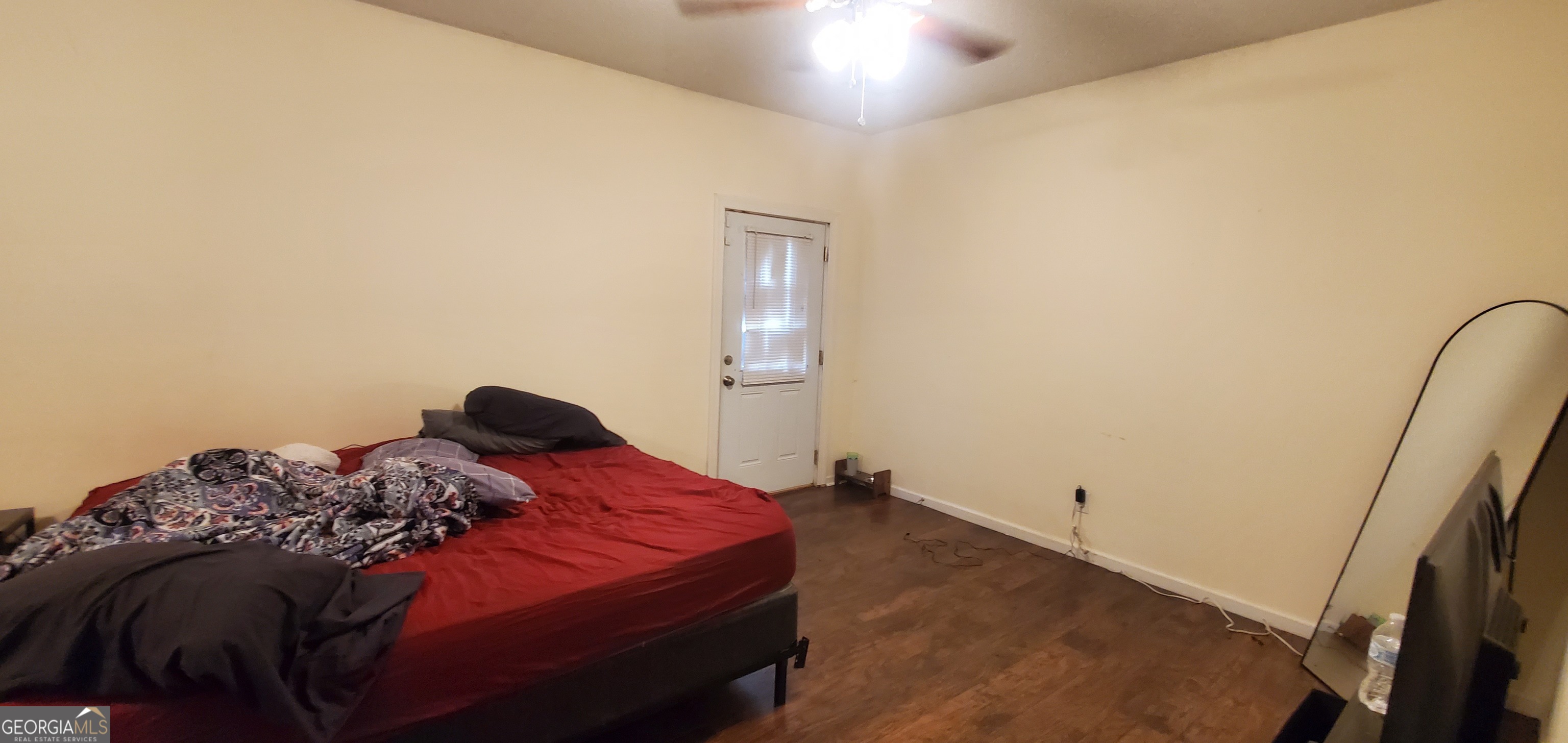 38 Highway 46 Lyons, GA 30436 - Photo 24 of 44 a bedroom with a bed and a flat tv screen on a dresser