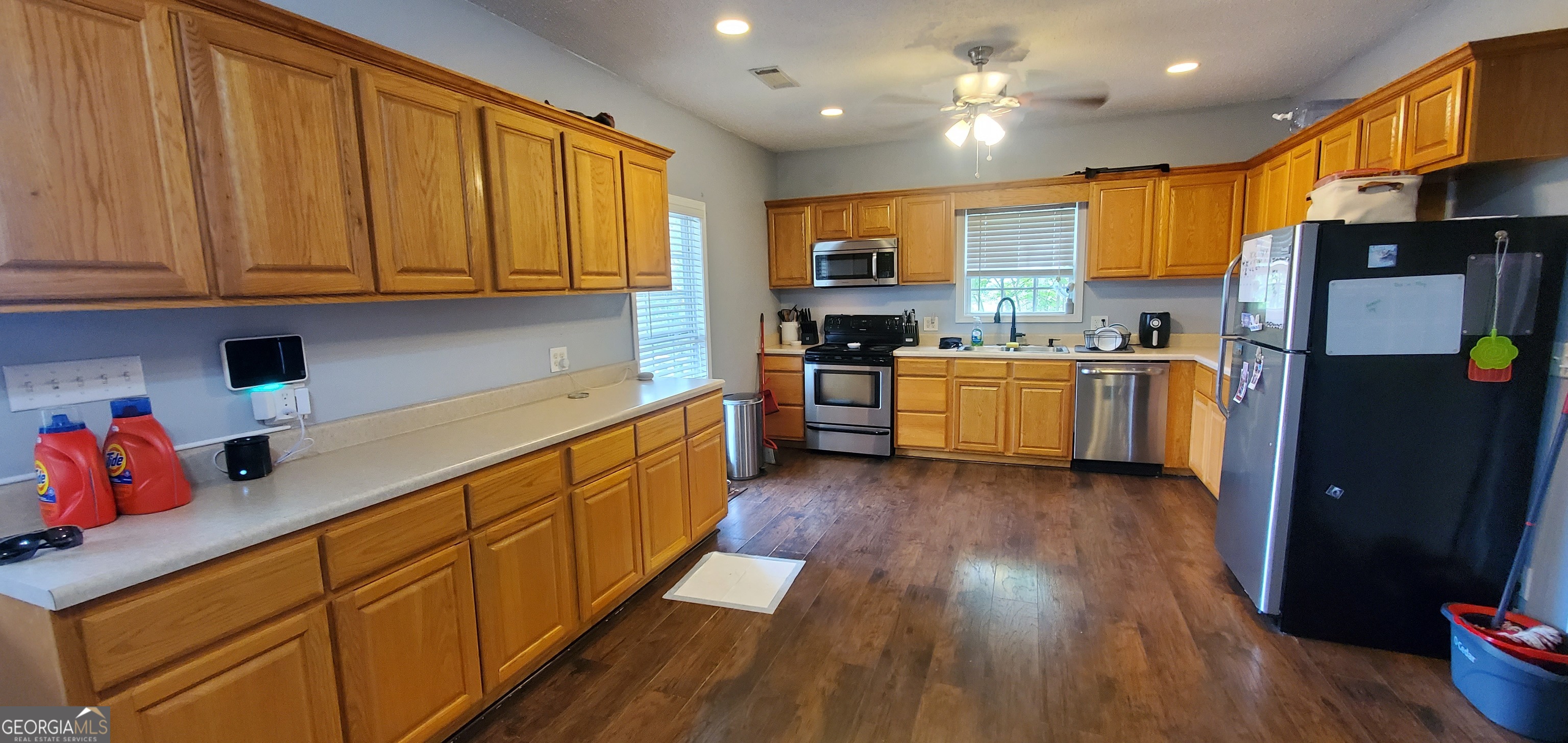 38 Highway 46 Lyons, GA 30436 - Photo 28 of 44 a kitchen with stainless steel appliances granite countertop wooden cabinets a refrigerator a stove a sink and dishwasher with wooden floor