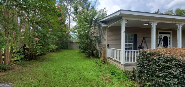 a view of a field with a tree in the background