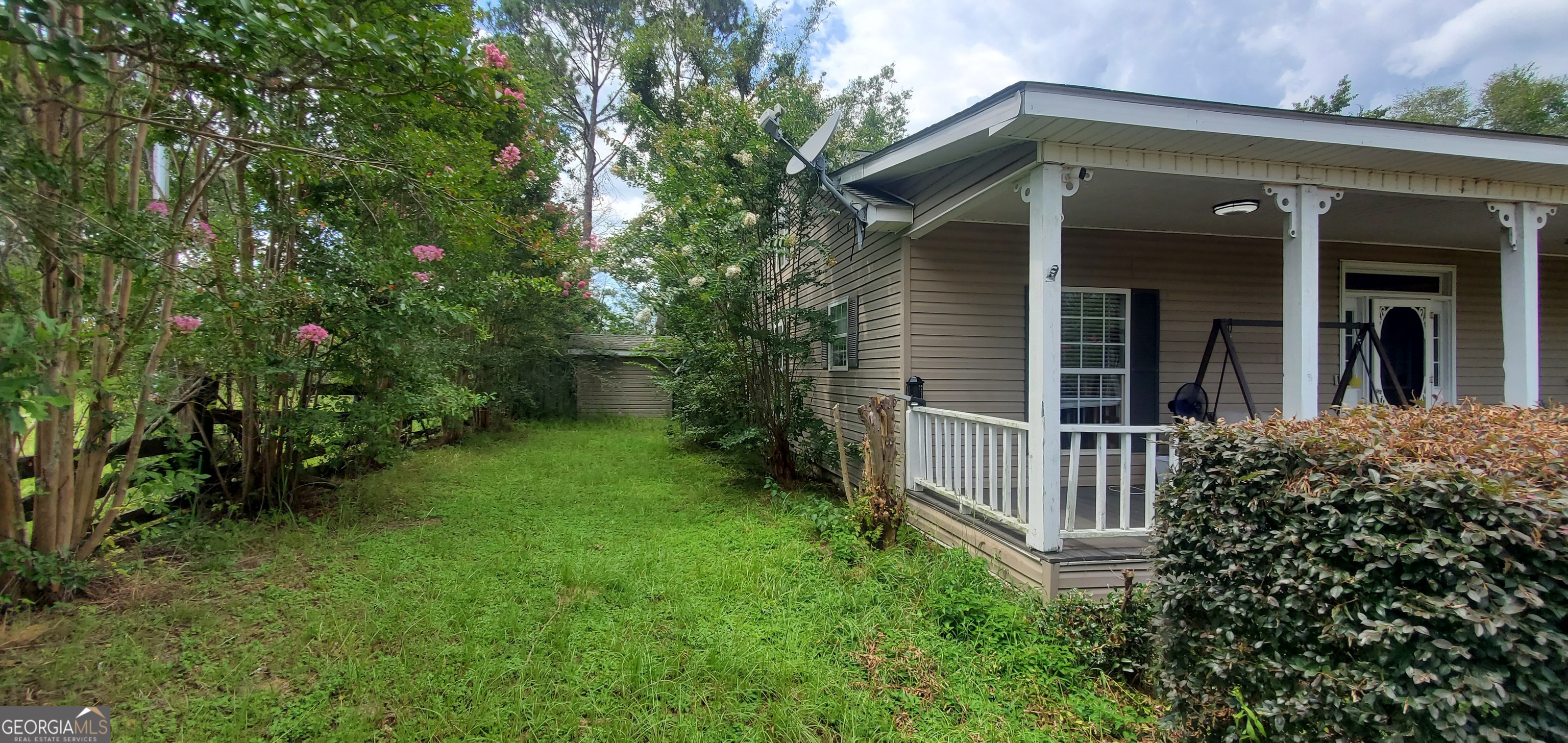38 Highway 46 Lyons, GA 30436 - Photo 35 of 44 a view of a house with a small yard plants and large tree
