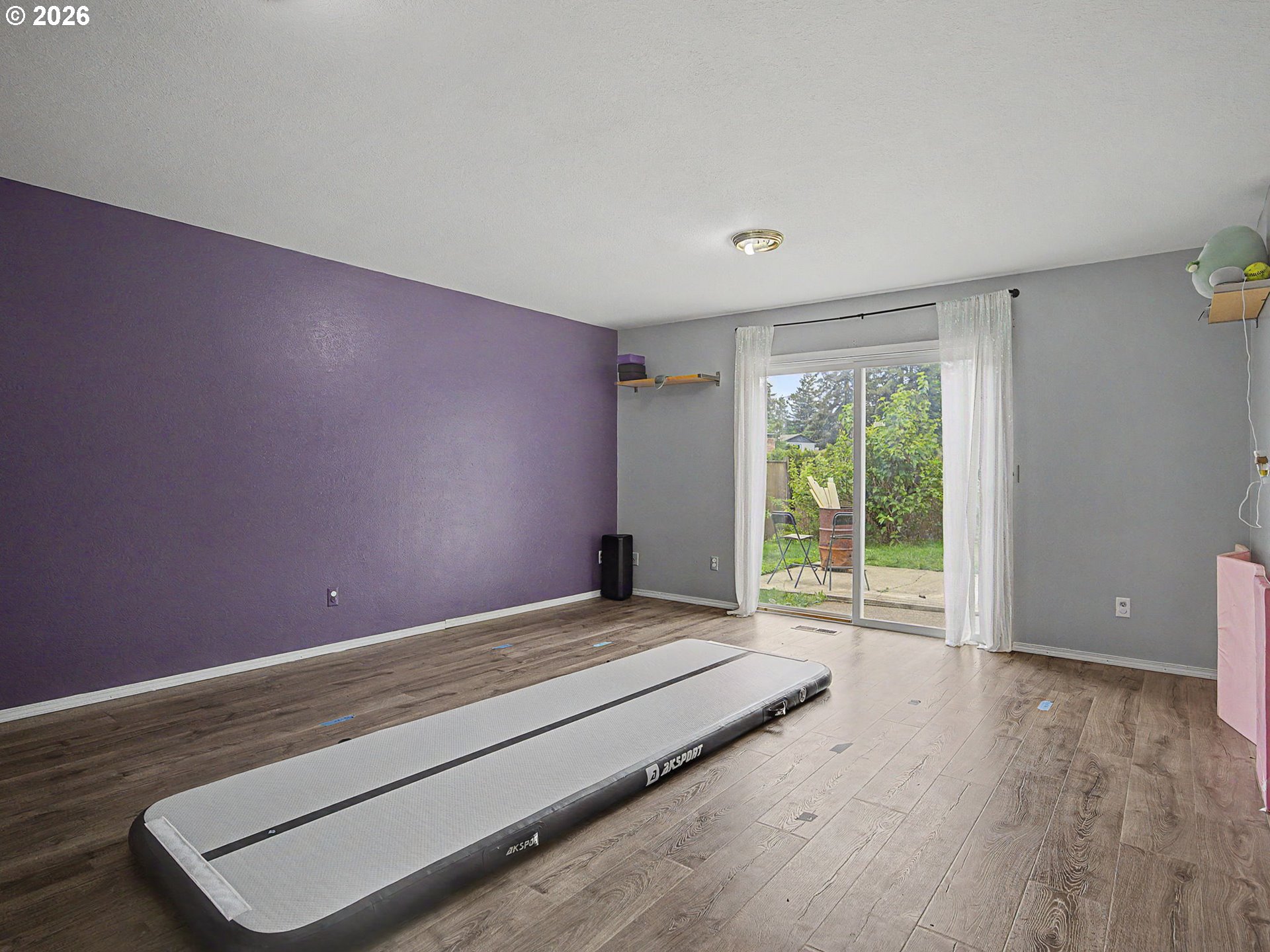18015 Davis Street Sandy, OR 97055 - Photo 28 of 40 a view of an empty room with wooden floor and a window