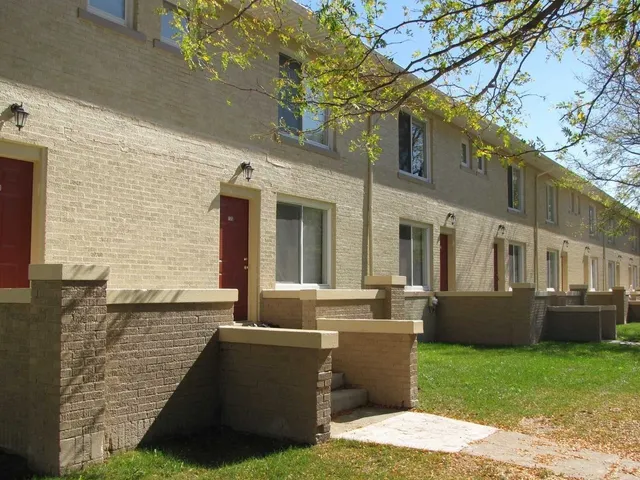 a view of house with backyard and outdoor seating