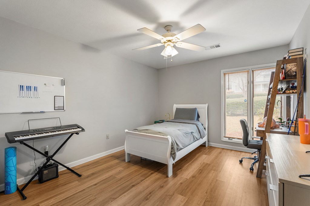 6831 Beaver Trail Midland, GA 31820 - Photo 20 of 24 a bedroom with a bed and a chandelier