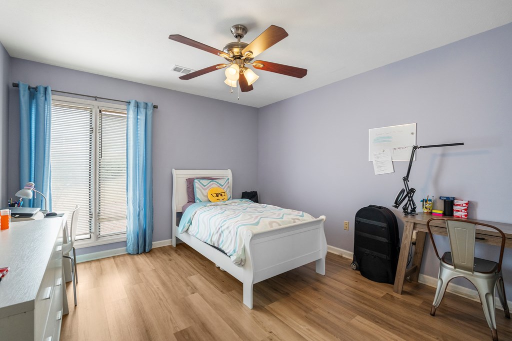 6831 Beaver Trail Midland, GA 31820 - Photo 21 of 24 a bedroom with a bed and a chandelier