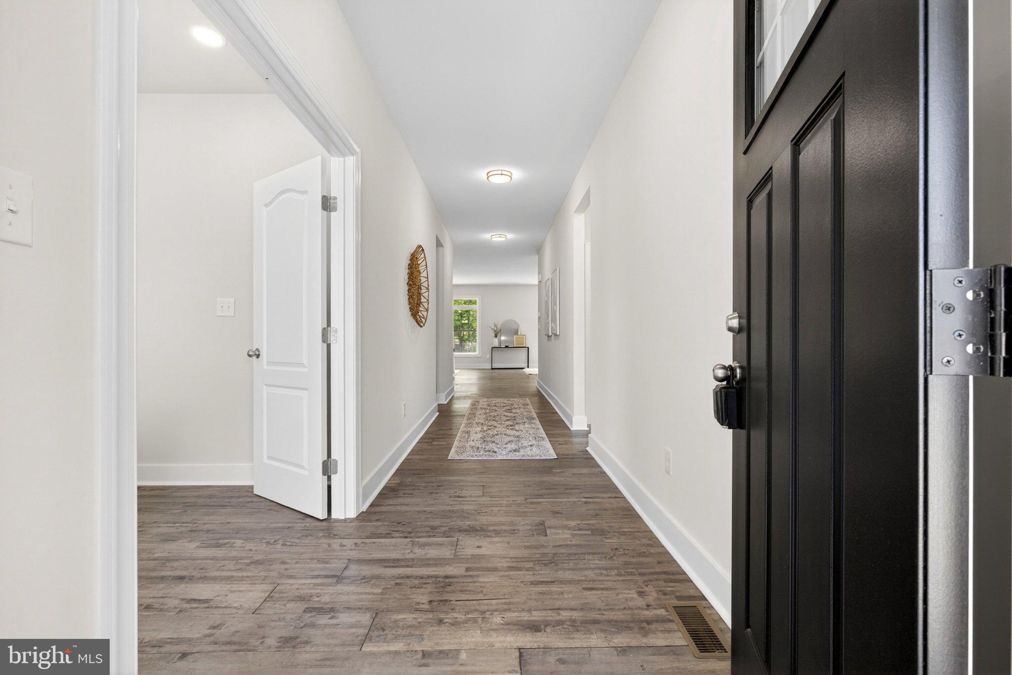 164 Pine Tree Road Townsend, DE 19734 - Photo 12 of 84 a view of a hallway with wooden floor and a bathroom