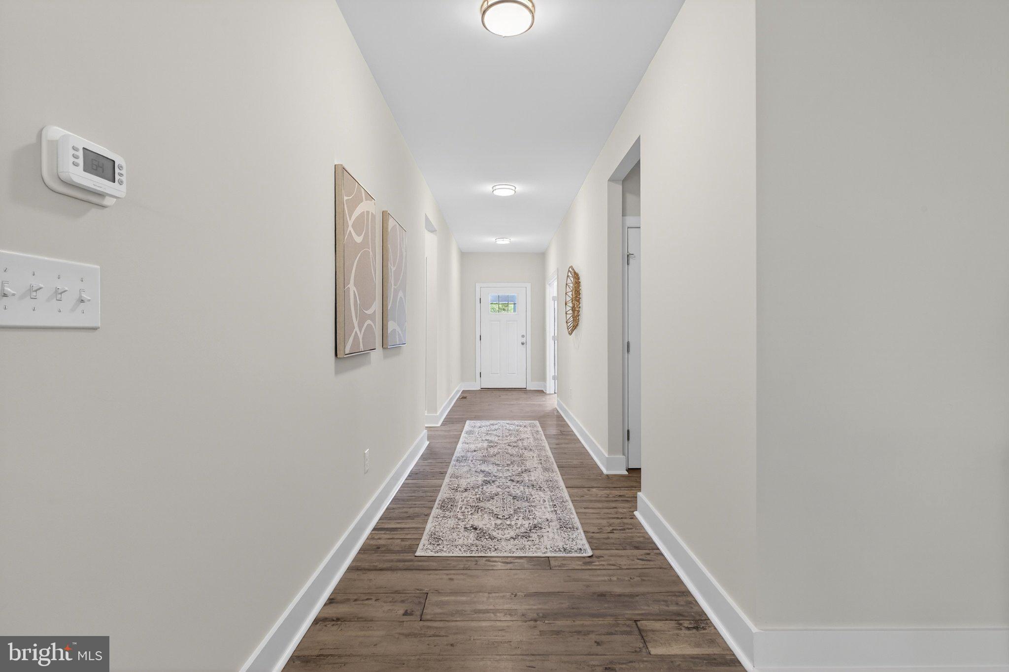 164 Pine Tree Road Townsend, DE 19734 - Photo 13 of 84 a view of a hallway with wooden floor