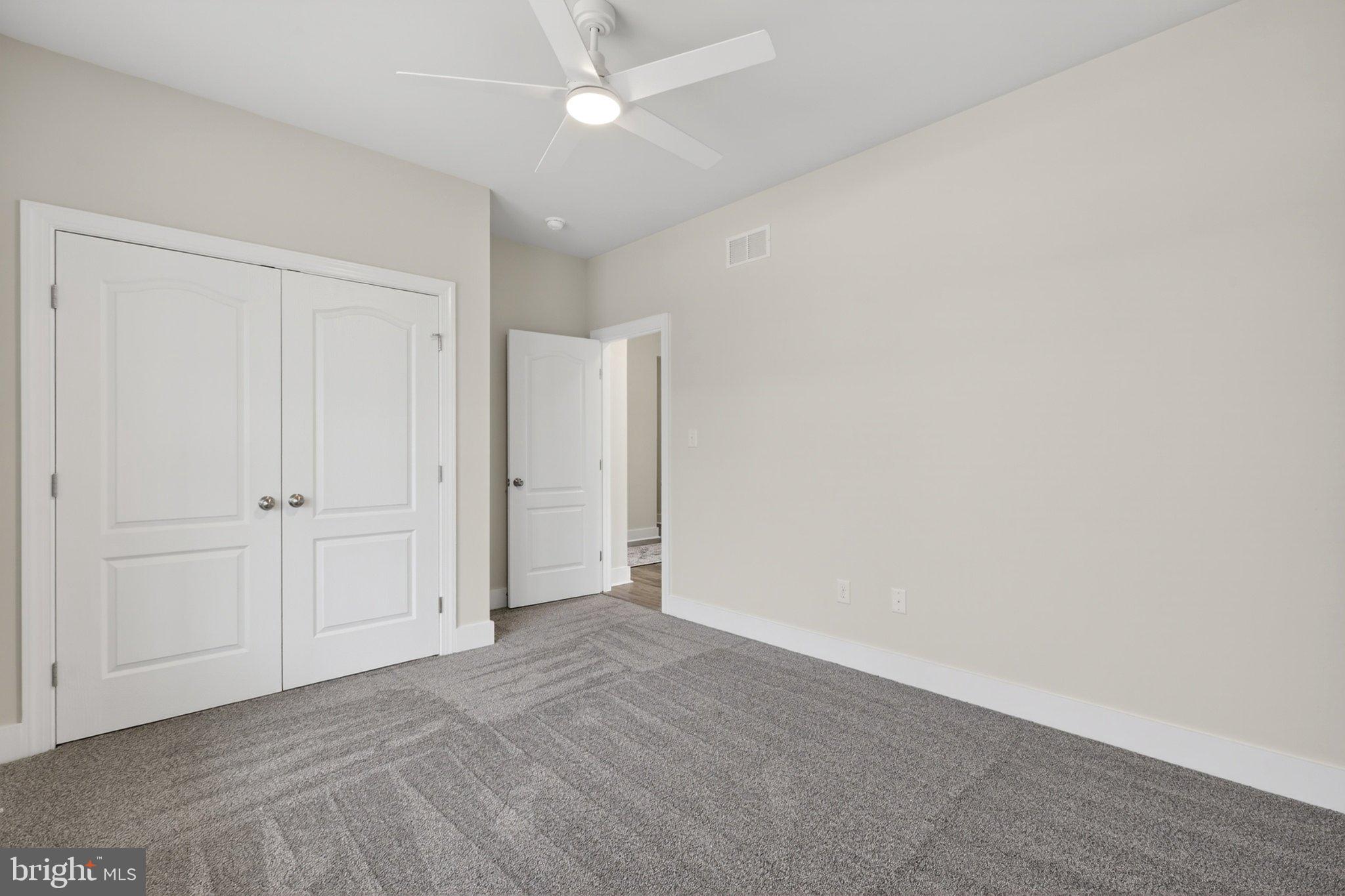 164 Pine Tree Road Townsend, DE 19734 - Photo 20 of 84 an empty room with a ceiling fan and closet