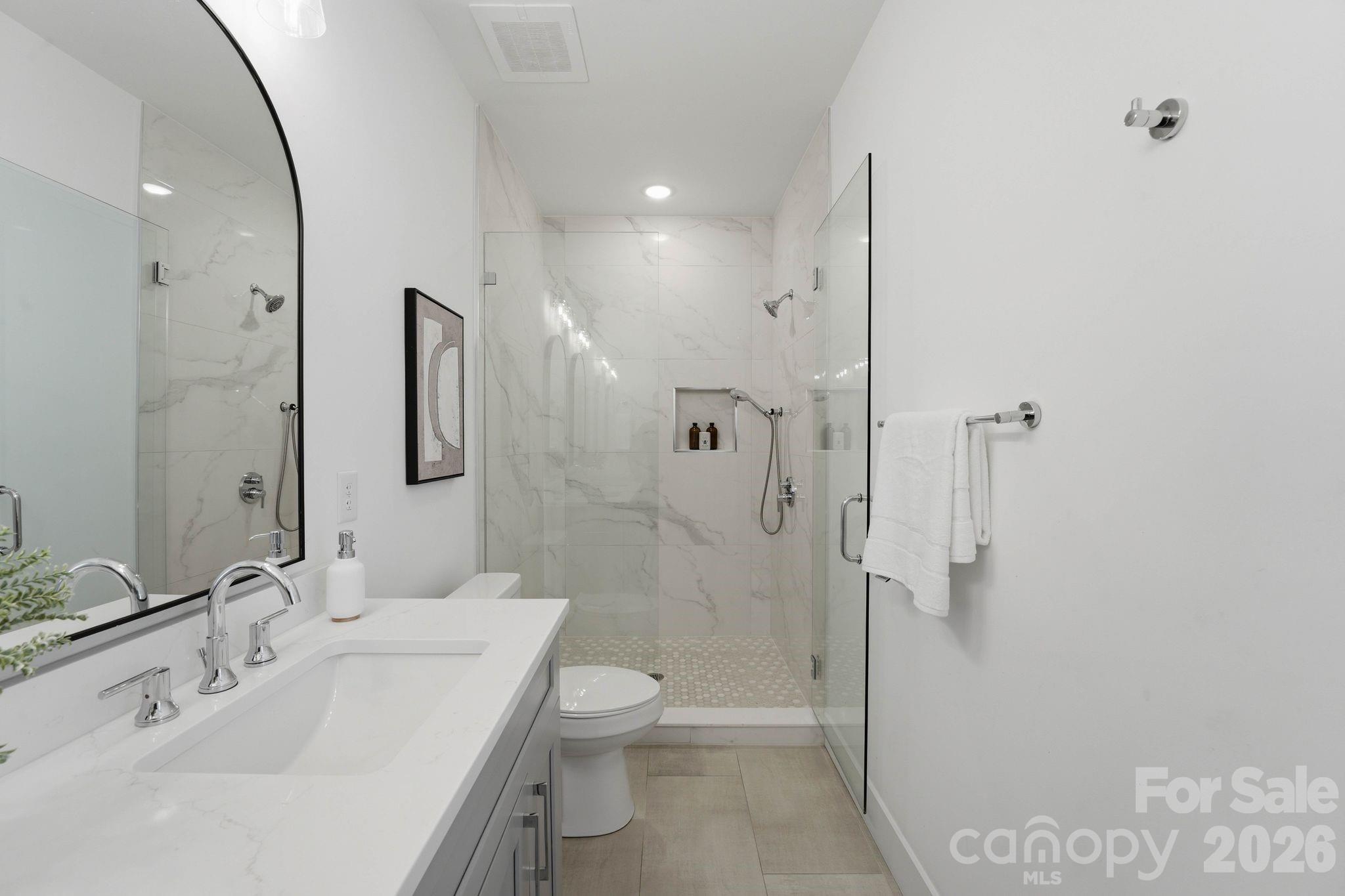 201 Grandin Road, Unit 6 Charlotte, NC 28208 - Photo 14 of 45 a bathroom with a sink a toilet and shower