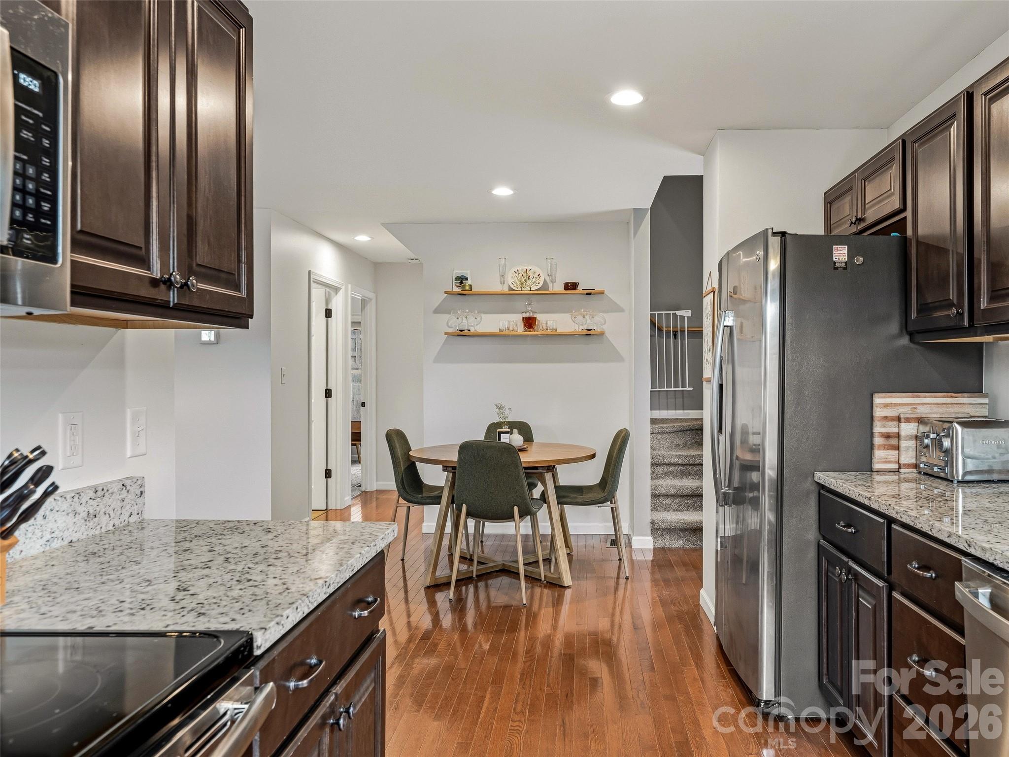 21 Yarrow Meadow Road Weaverville, NC 28787 - Photo 12 of 38 a kitchen with stainless steel appliances granite countertop a kitchen island hardwood floor and a sink