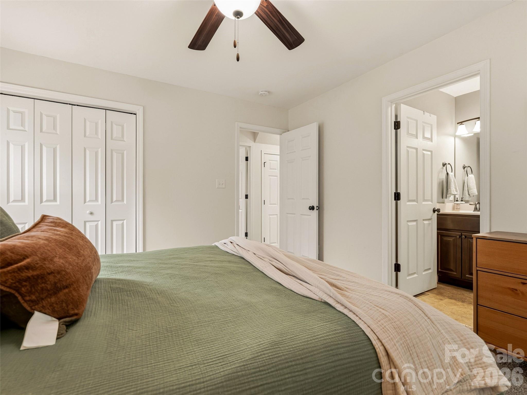 21 Yarrow Meadow Road Weaverville, NC 28787 - Photo 14 of 38 a bedroom with a bed and a chandelier