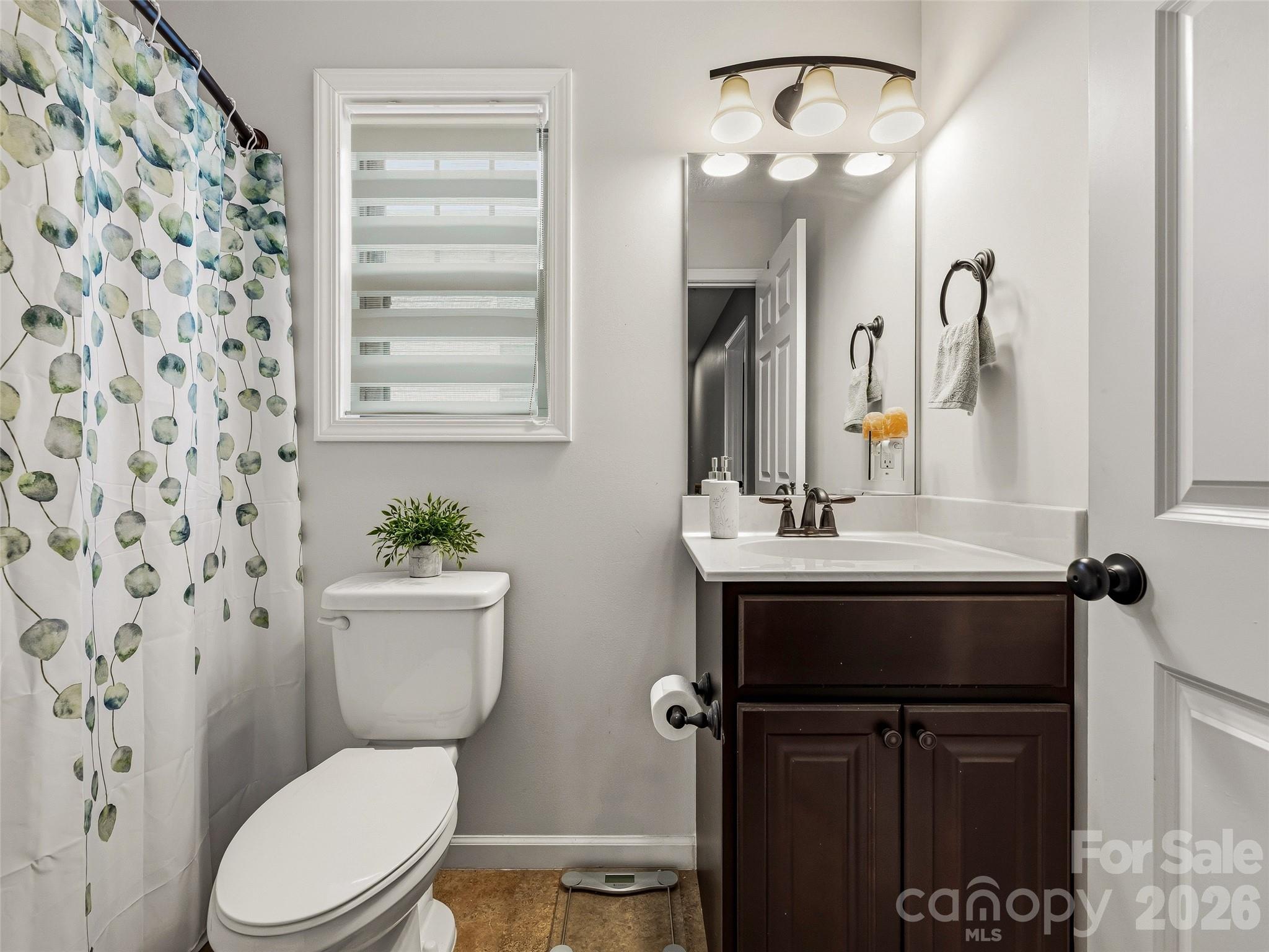 21 Yarrow Meadow Road Weaverville, NC 28787 - Photo 22 of 38 a bathroom with a sink a toilet a mirror and shower curtain