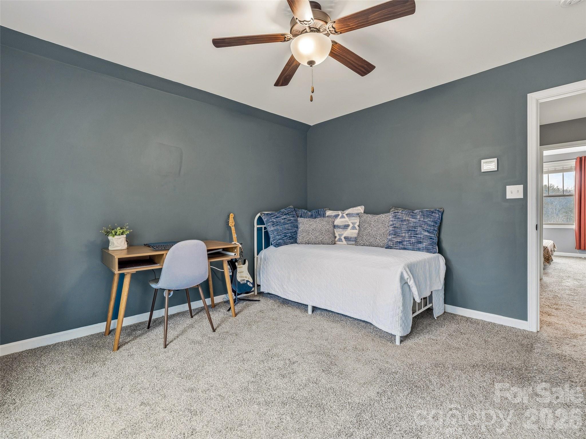 21 Yarrow Meadow Road Weaverville, NC 28787 - Photo 23 of 38 a bedroom with a bed a table and a chandelier