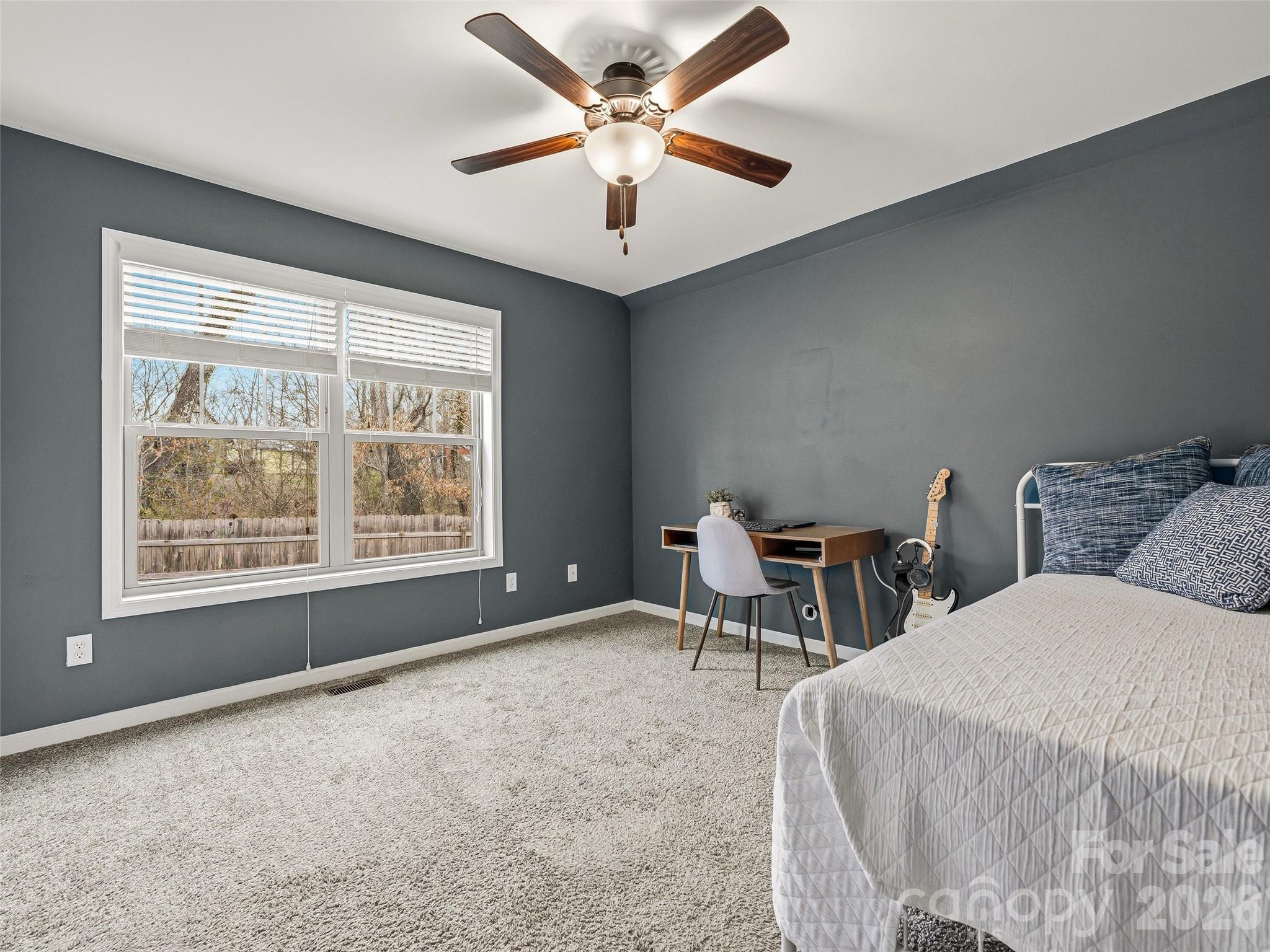 21 Yarrow Meadow Road Weaverville, NC 28787 - Photo 24 of 38 a bedroom with a bed and a chandelier