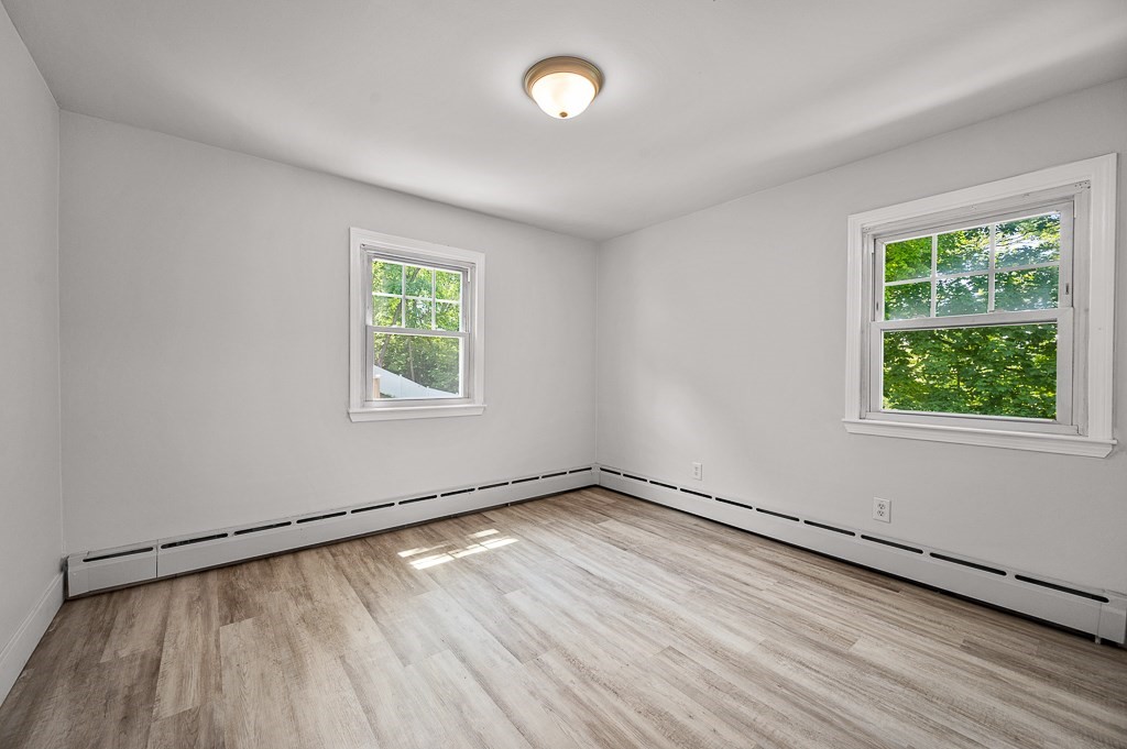 10 Maplewood Road Worcester, MA 01602 - Photo 13 of 24 an empty room with wooden floor and windows
