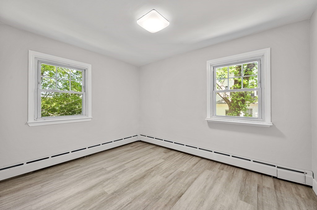 10 Maplewood Road Worcester, MA 01602 - Photo 16 of 24 an empty room with wooden floor and windows