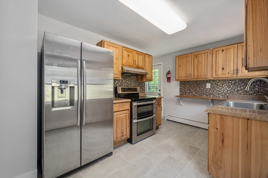 10 Maplewood Road Worcester, MA 01602 - Photo 8 of 24 a kitchen with granite countertop a refrigerator stove and sink