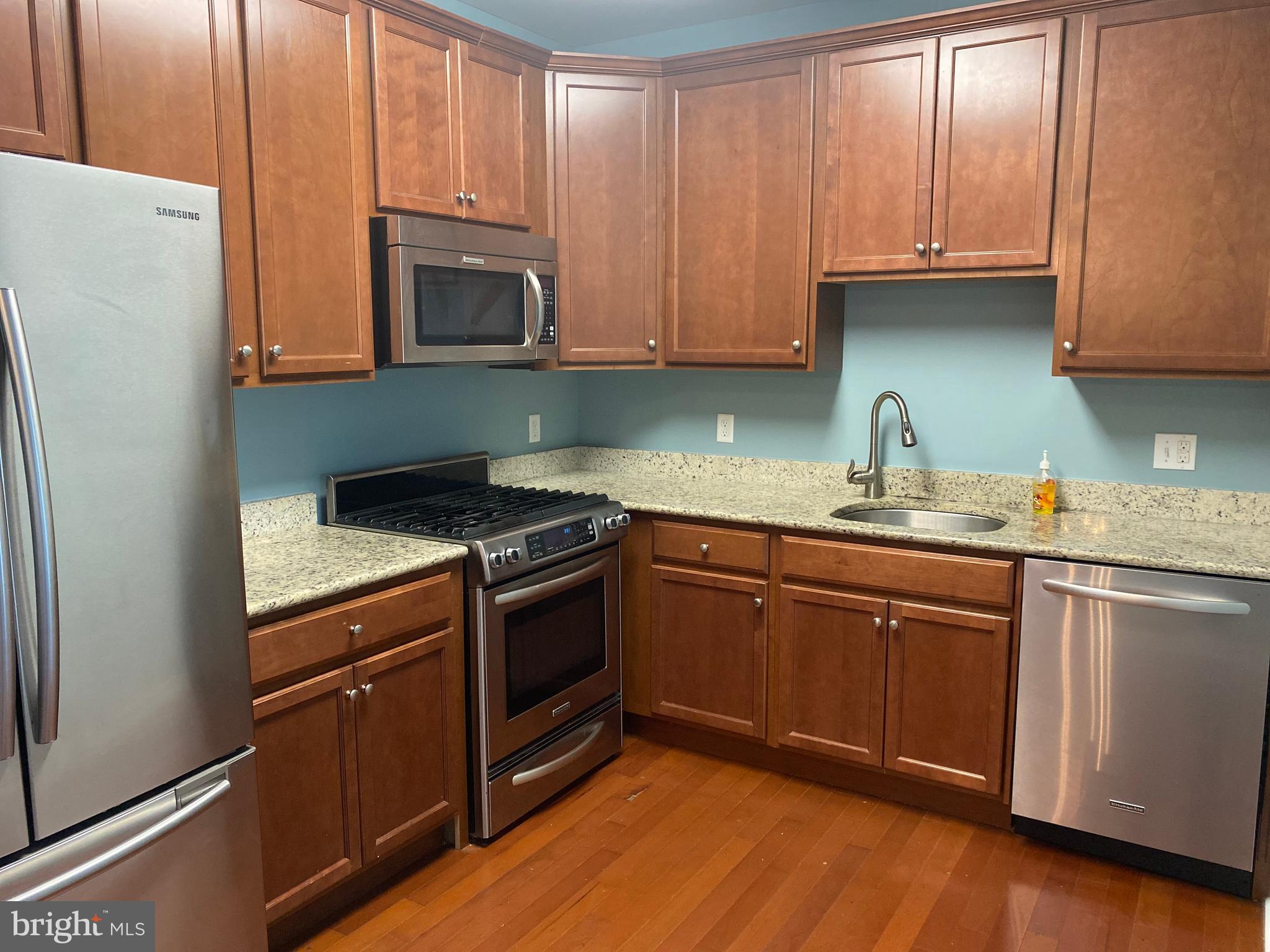 4333 Champions Run Cherry Hill, NJ 08002 - Photo 6 of 14 a kitchen with granite countertop wooden cabinets and a stove top oven