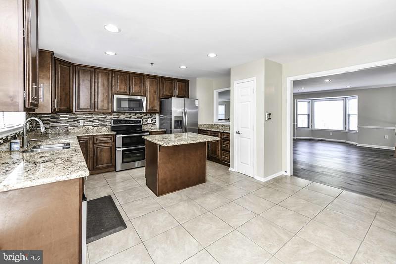 2 Parker Farm Court Silver Spring, MD 20906 - Photo 24 of 34 a kitchen with stainless steel appliances granite countertop a sink counter space cabinets and a large window