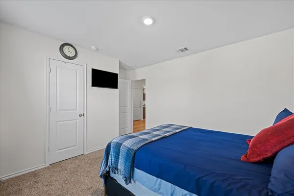 a bedroom with a bed and a closet