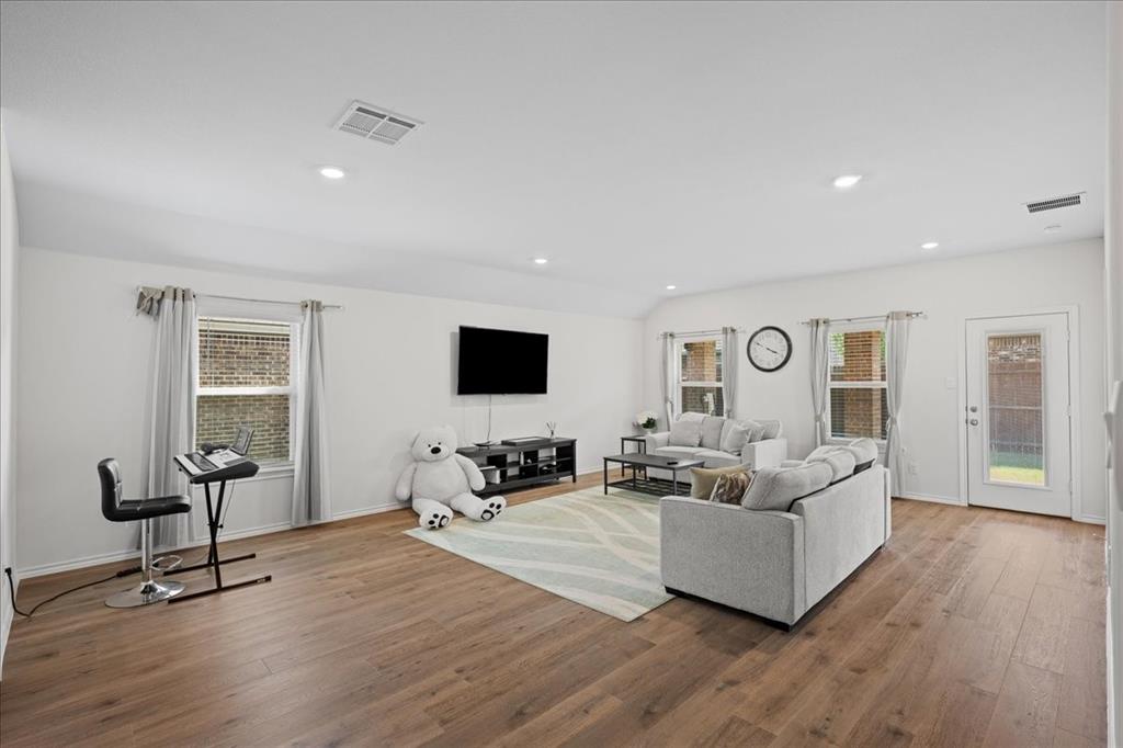 217 Redbarn Lane Caddo Mills, TX 75135 - Photo 6 of 21 a living room with furniture and a flat screen tv