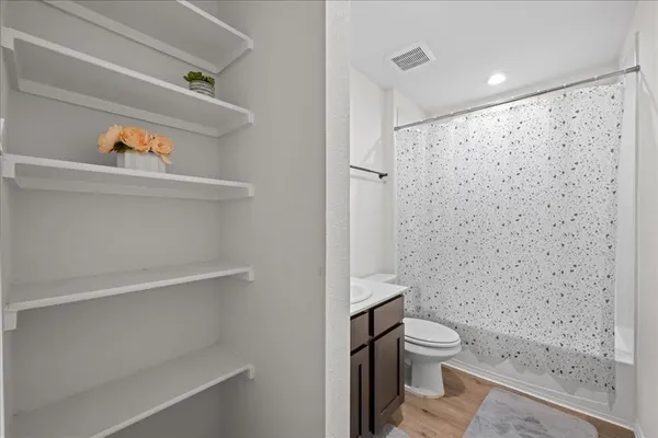 a bathroom with a toilet and a shower