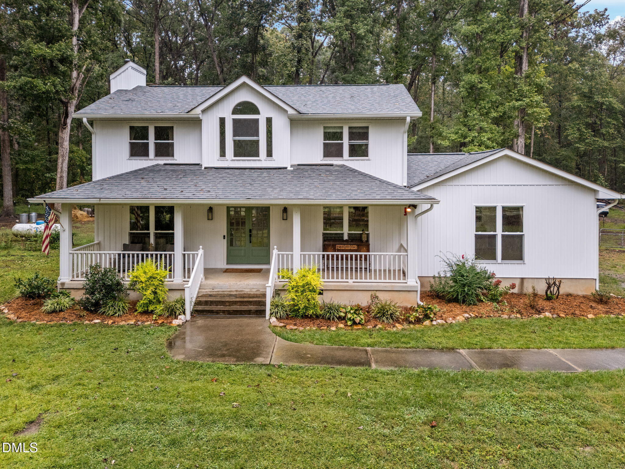 a front view of a house with a yard and porch