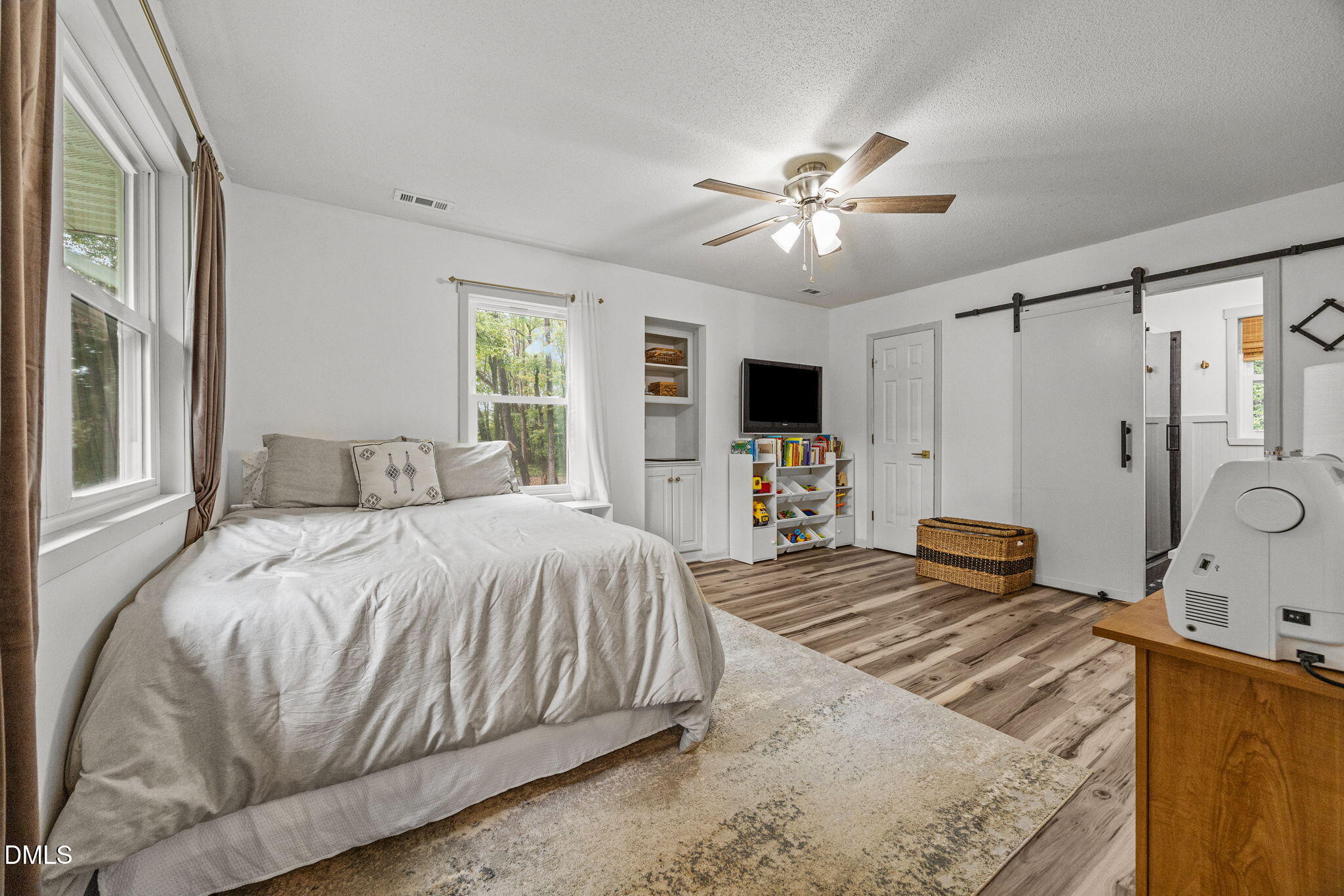 320 Dewitt Smith Road Pittsboro, NC 27312 - Photo 25 of 40 a bedroom with a bed and a flat tv screen on dresser