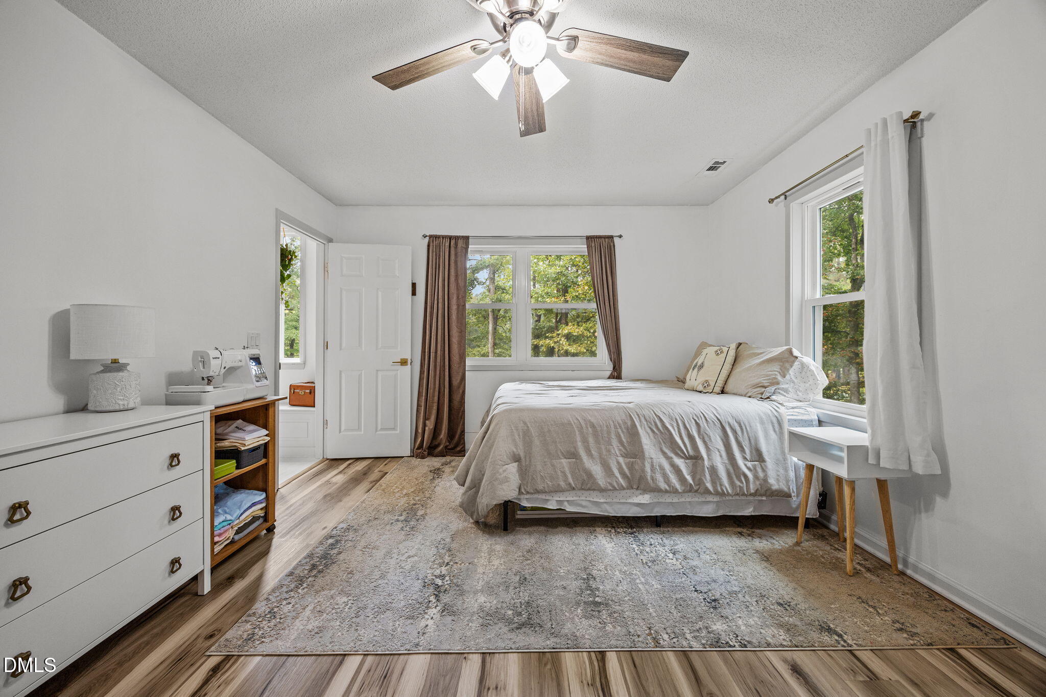 320 Dewitt Smith Road Pittsboro, NC 27312 - Photo 26 of 40 a spacious bedroom with a bed and a chandelier