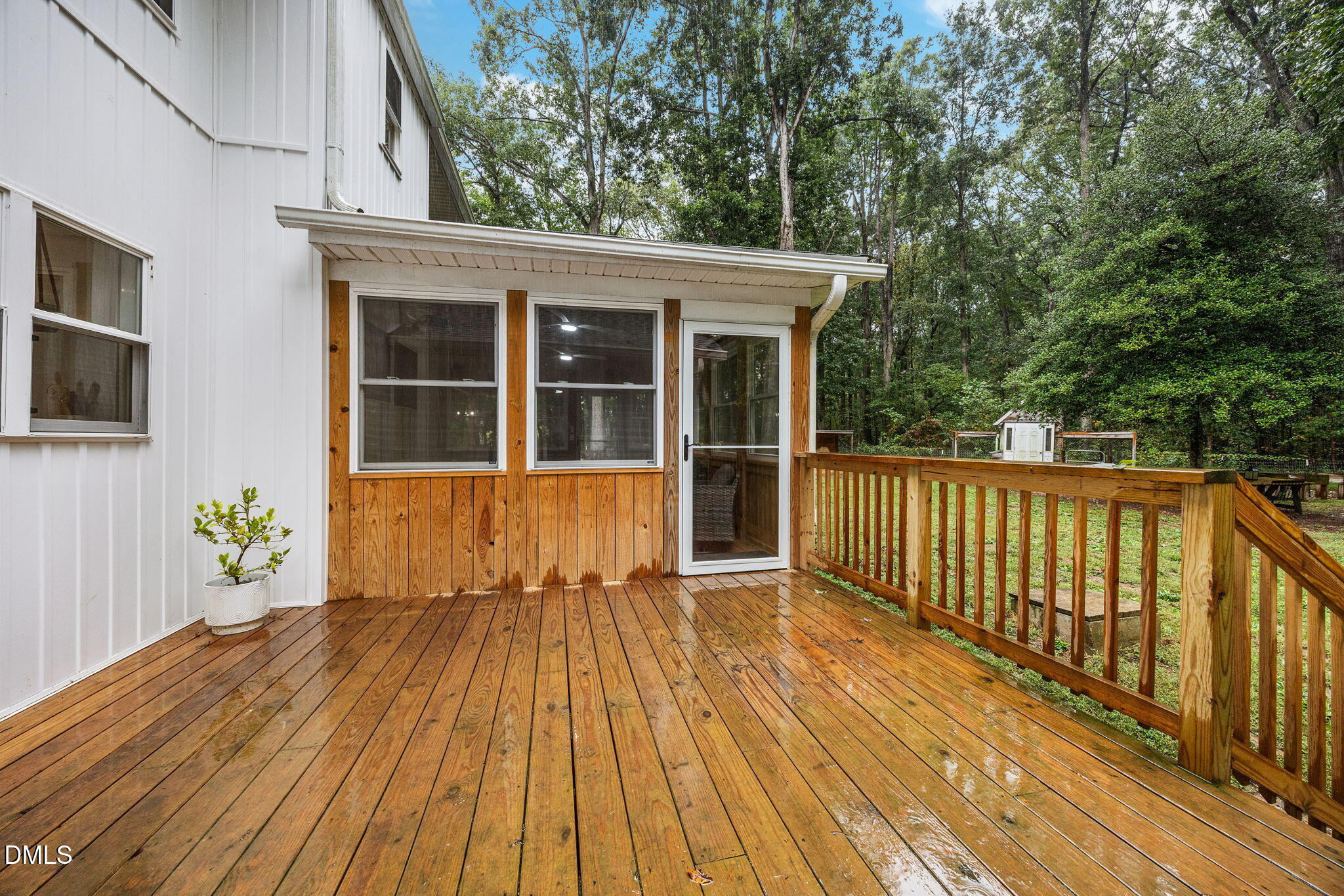 320 Dewitt Smith Road Pittsboro, NC 27312 - Photo 30 of 40 a view of a house with a wooden floor and a table with potted plants