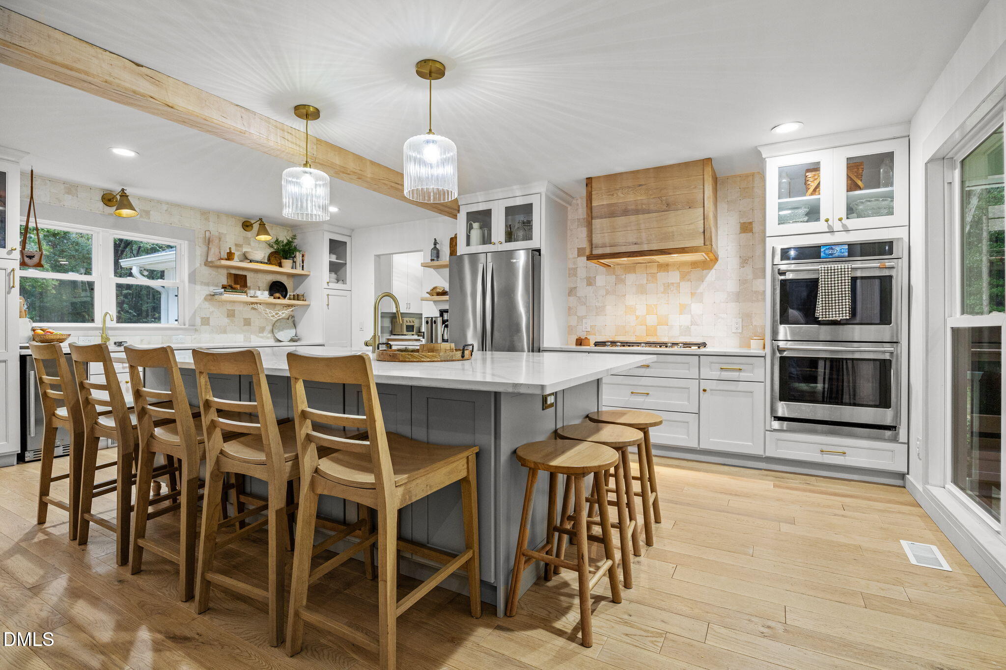 320 Dewitt Smith Road Pittsboro, NC 27312 - Photo 9 of 40 a kitchen with stainless steel appliances kitchen island granite countertop a table and chairs in it