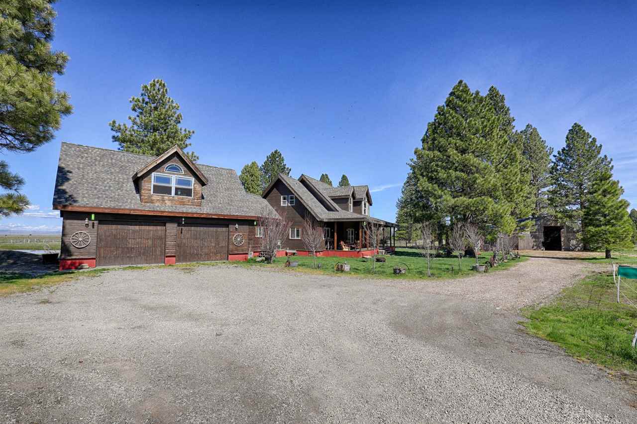 21040 Highway 89 Calpine, CA 96124 - Photo 2 of 21 a front view of a house with a yard and garage