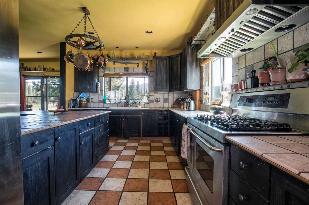 21040 Highway 89 Calpine, CA 96124 - Photo 7 of 21 a kitchen with a sink and wooden cabinets