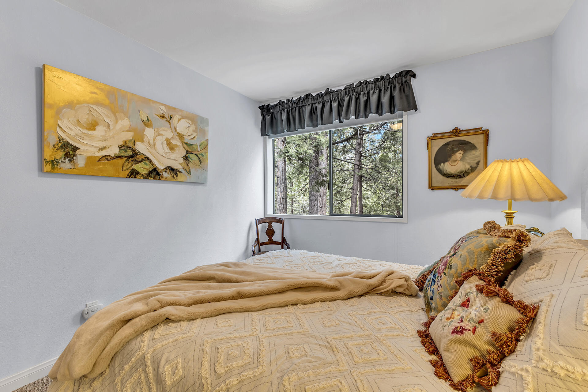 54580 Reed Lane Idyllwild, CA 92549 - Photo 59 of 101 a bedroom with a bed and a lamp on dresser