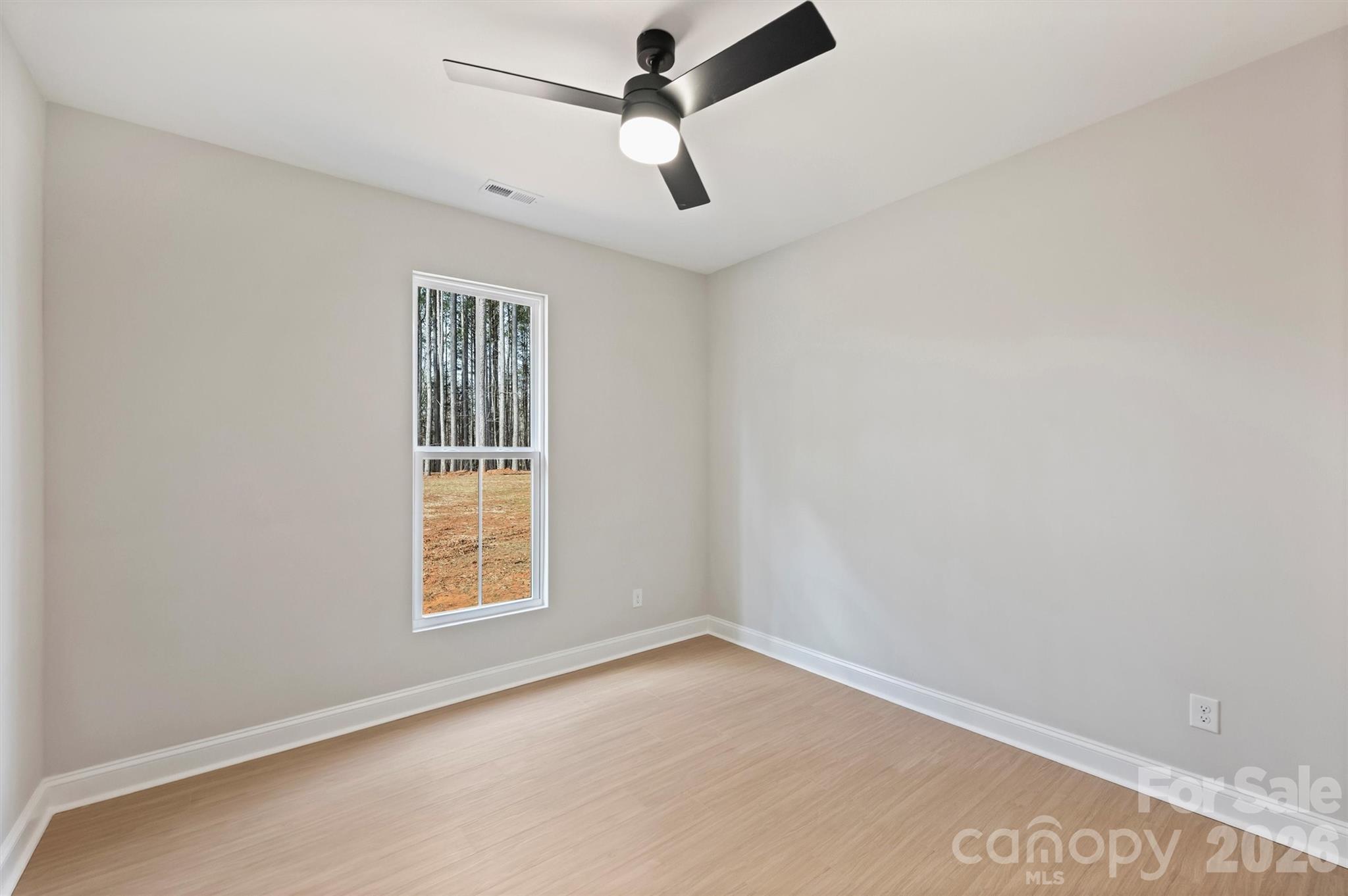 2295 Lee Lawing Road Lincolnton, NC 28092 - Photo 33 of 43 an empty room with ceiling fan and windows
