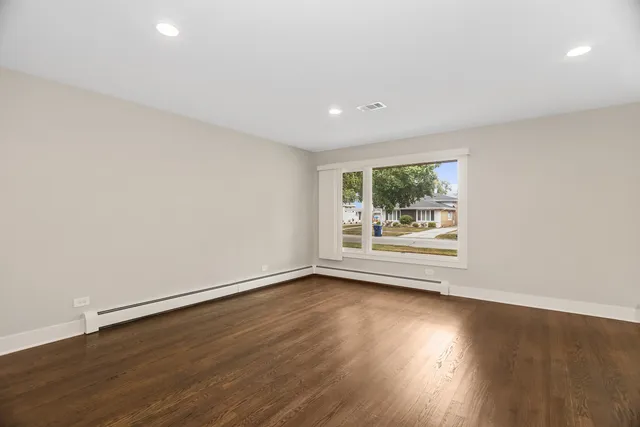 a view of room with window and wooden floor