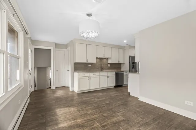 a kitchen with white cabinets and white appliances
