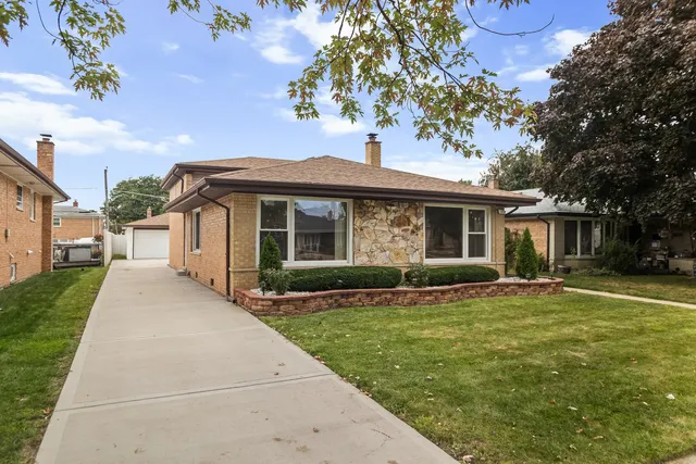 a front view of a house with a garden