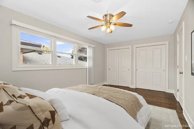 a bedroom with a large bed and a painting on the wall