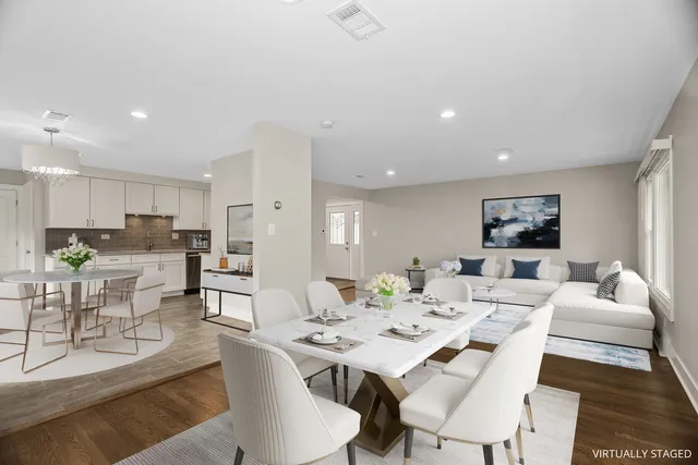 a living room with lots of furniture and view of kitchen