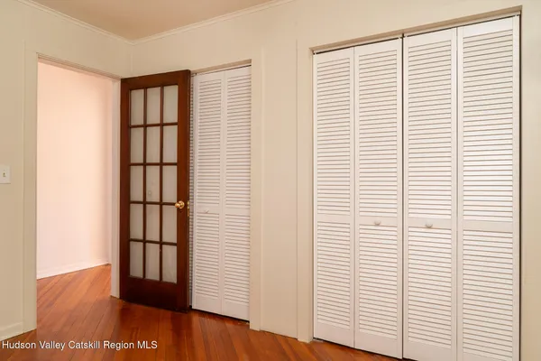 a view of a room with wooden floor and a window