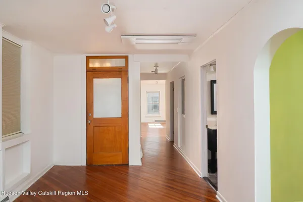 a view of a hallway with wooden floor